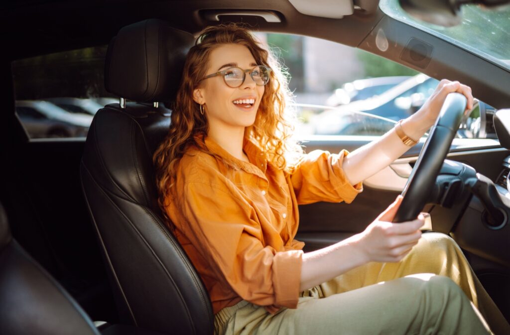 Person wearing glasses while operating a motor vehicle.