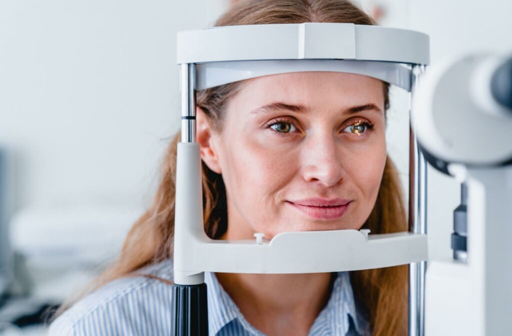 A patient at an eye exam having their eyes examined by a slit lamp.